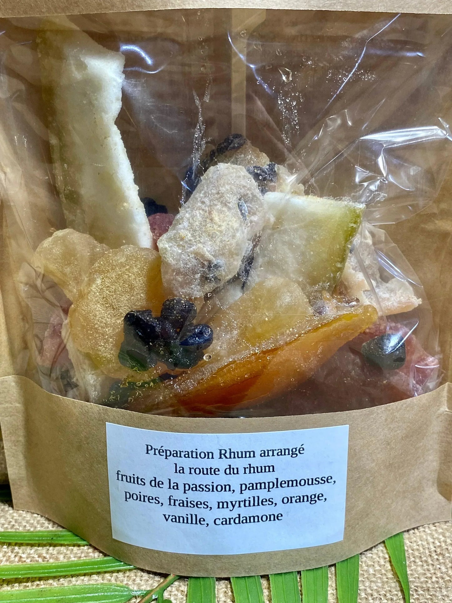 gros plan sur les ingrédients du sachet de rhum arrangé La Route des Rhums – fruits de la passion, pamplemousse, poires, fraises, myrtilles séchées, orange, sucre vanillé bourbon et cardamome pour infusion dans le rhum
